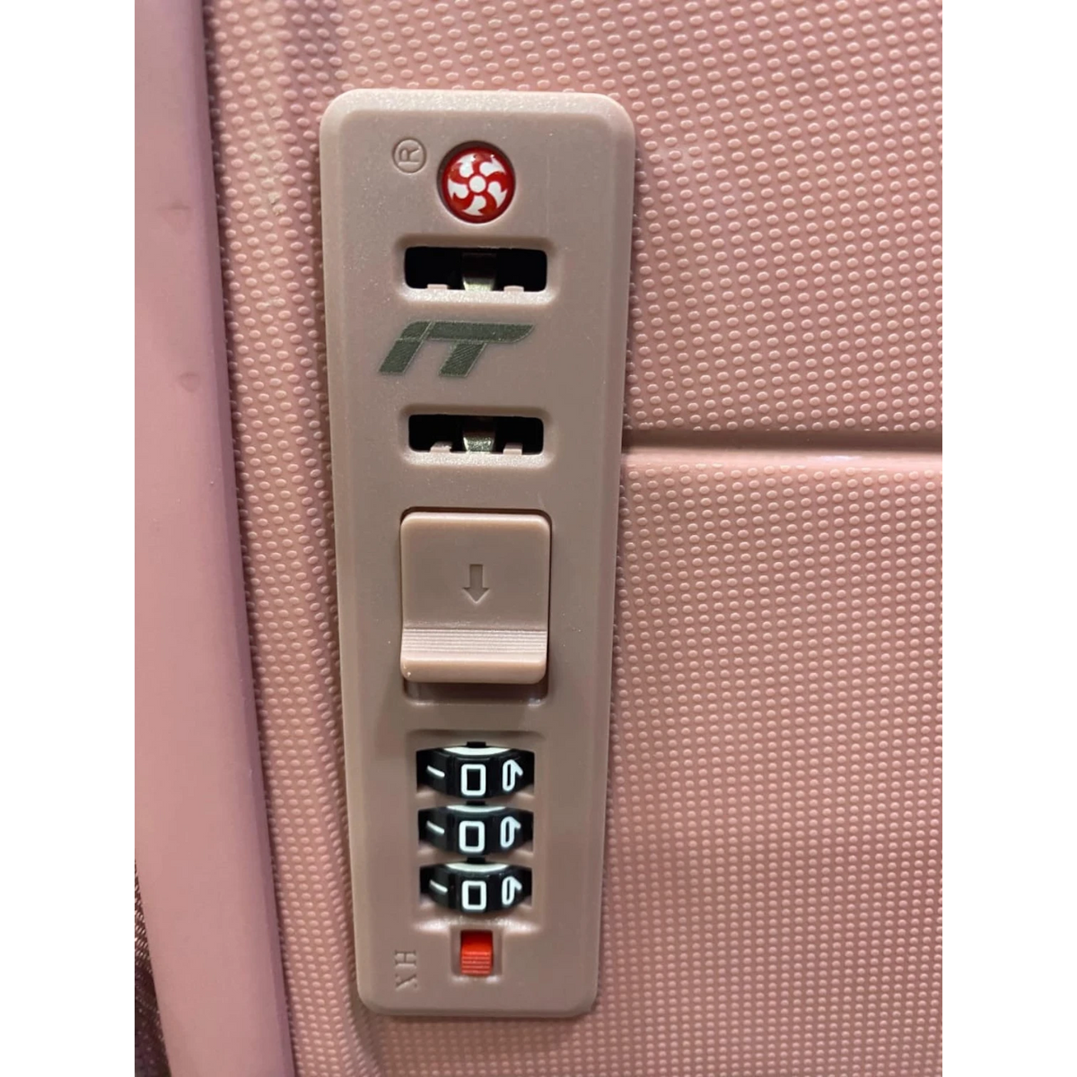 Fixed Price Shop INTERNATIONAL TRAVELLER suitcase integrated combination lock on a textured pink hard shell surface