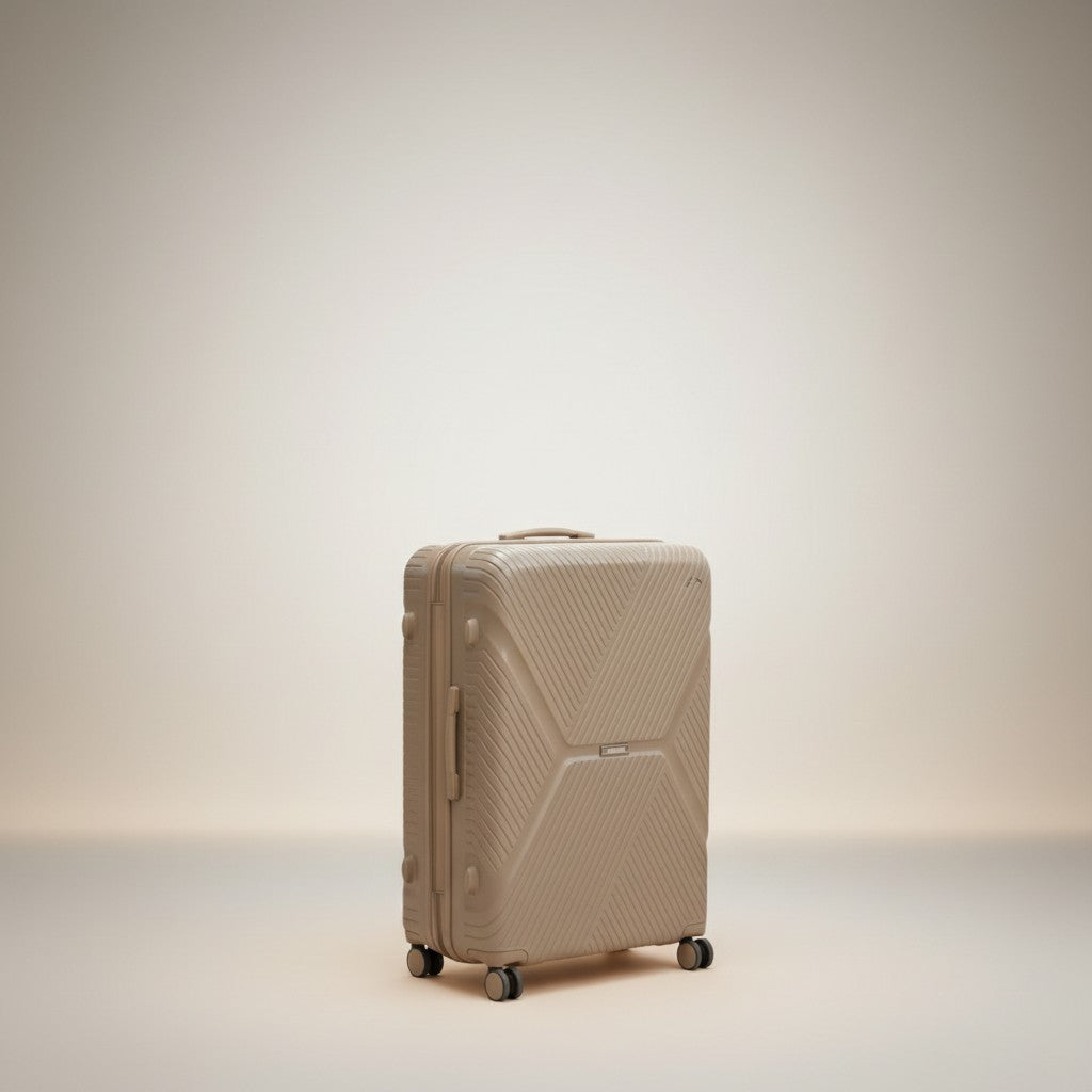 Man standing with a large, taupe American Tourister suitcase with textured detailing and 360 wheels. The luggage has an expandable zipper and TSA lock.