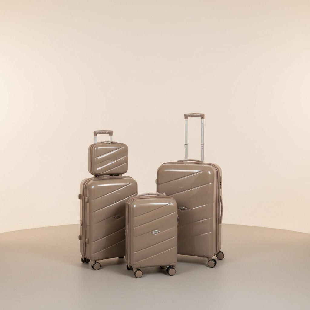 Fixed Price Shop man with a set of four champagne-colored polypropylene luggage pieces, featuring an anti-theft zipper and TSA lock.