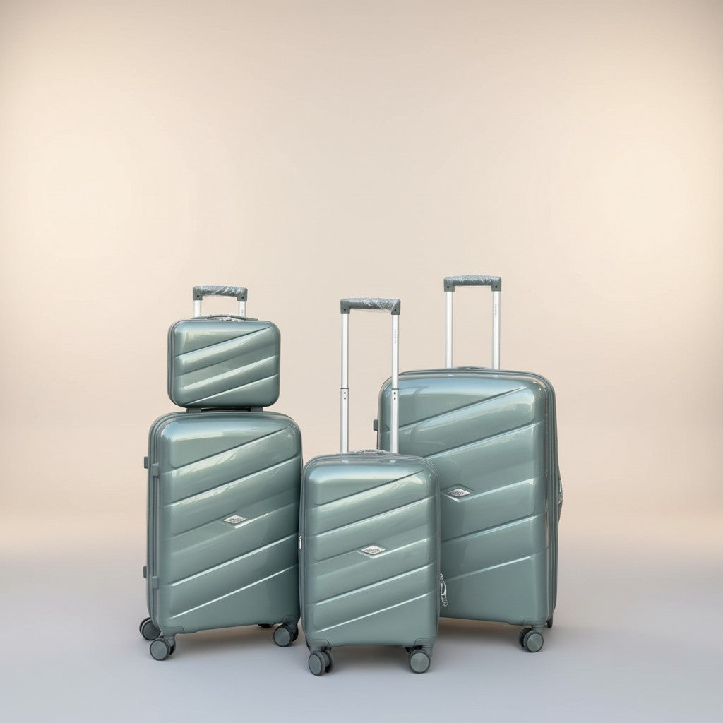 Fixed Price Shop man presenting a set of 4 light green polypropylene luggage with expandable zippers and TSA locks.