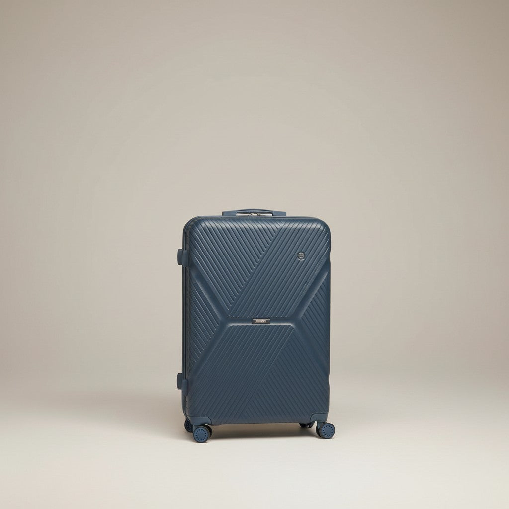 Man with a navy blue American Tourister suitcase with TSA lock and expandable zipper on a cobblestone street.
