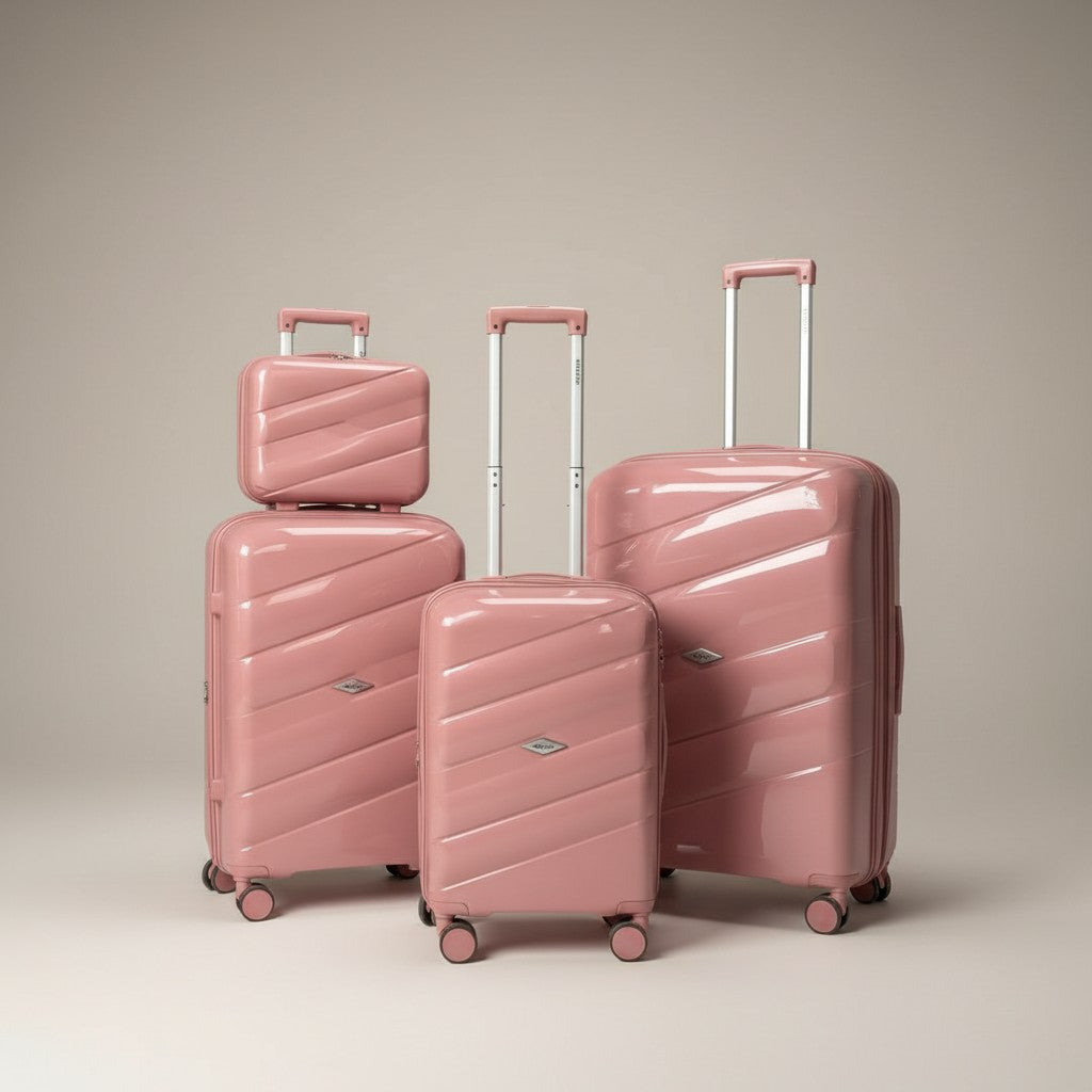 Fixed Price Shop pink polypropylene luggage set with antitheft zipper and TSA lock. Model poses with four pieces.